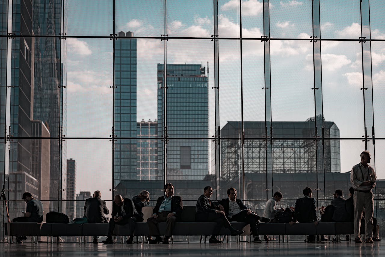 Business professionals at the Javits Center, New York City featuring urban skyline through glass facade.